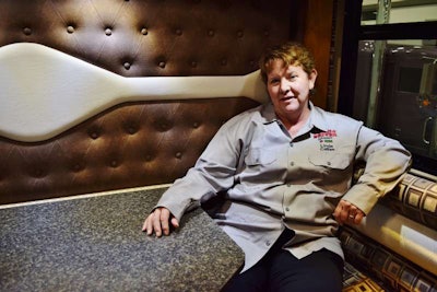 Linda Caffee gives kudos to A.J. Elliott for work on the custom button-tuck upholstery on the interior, outfitted with many of the comforts of home — refrigerator and other kitchen appliances, sink, plenty cabinetry for storage, fold-out dine-a-bunk.