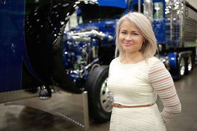 Driver Ann Sosnia, a finalist in Overdrive’s Most Beautiful, visits Brian Davis’ Peterbilt at the Great American Trucking Show.