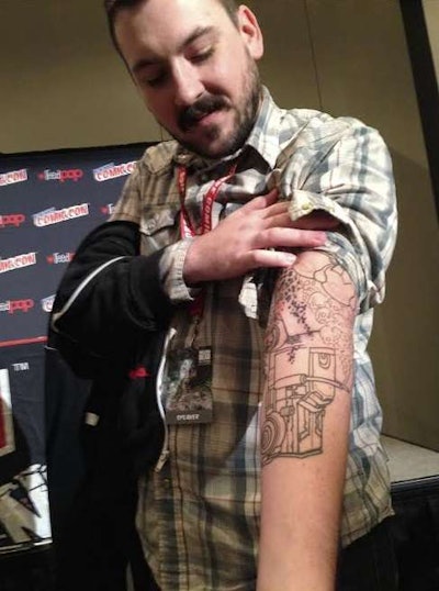 Former Austin, Texas, comics store owner Cates, pictured above, tattoed his right arm with an illustration based on one of the panels in the comic to, in Hollis’ words, “remind him of the deadlines that hang over his head now that he is a successful comic book author.”