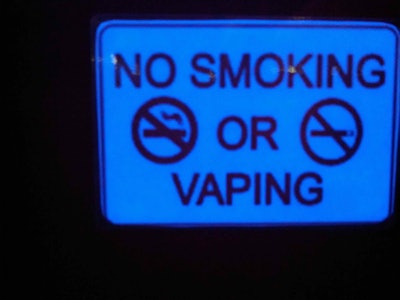 Signs like this one, illuminated by blacklight in a crowded bowling alley in Nashville, Tenn., are popping up with the proliferation of new vapers.