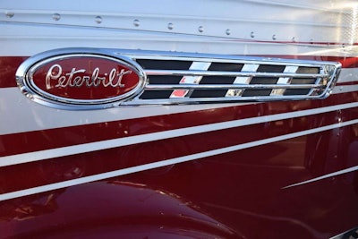 A few of the entries in the PKY Truck Beauty Championship have this enhanced Pete branding on the hood. It indicates a Pride & Class edition truck, which also features a special grille and custom features on the interior. This one is on a 2015 Pete 389 owned by First Class Services.