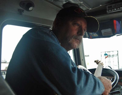 Howard Salmon with guitar in-cab