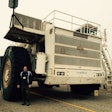 Trucking journalist David Kohlman stands by the M200 tires, which are almost 13 feet tall and weigh 12,000 pounds.
