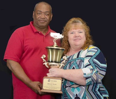 Boyd Transportation professional driver, Johnnie Cobb, and driver manager Ruth Brummitt proudly hold a trophy the company awarded to Cobb for achieving 3 million consecutive safe miles.