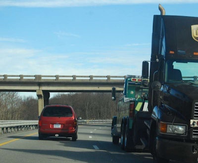 Truck being towed on highway