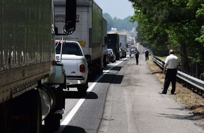 On a day that saw a tornado touch down in Oklahoma and dire radio reports about how dry it is out in California as fire season kicks off, turns out a few roadside brush fires were to blame for this shutdown. Here the one ahead of me is shown after another Gwinnett County water truck arrived on the scene to douse this particularly persnickety blaze.