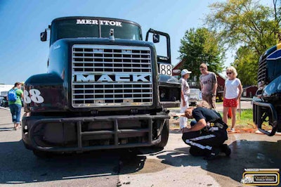 Mike Morgan taking a look at his brakes following the weekend's main event Podium Race, during which Morgan's brakes overheated.