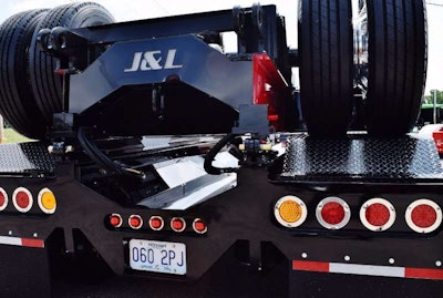 Rear view, with custom logo cuts made upside down to display in correct orientation when the auxiliary axle is up.