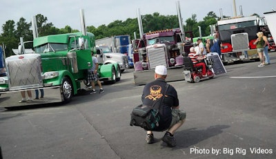 George Parker has been over-the-road trucking for about seven years. I happen to know this guy pretty well — I’ve been married to him for forty-leven (20) years. I know a lot about him, but you might not know that while he’s out here trucking his work is being featured on the cover of the August/September issue of Land Line, among other places. He sells stock photography to the trucking industry now, but once upon a time, Mr. Parker was a rock ‘n’ roll photographer for Clear Channel One, and I may be biased a little, but he’s one of the best technical and event photographers out there. “The year I finished photography school the first digital format camera hit the market,” he says, “and I knew then it would be hard to make a living as a photographer. I went into trucking to support my family. I’m a trucker, that’s what I do. I’m lucky enough to have a hobby I can make a little extra money doing that I enjoy.”