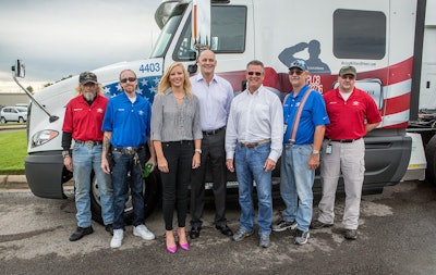 USA Truck presented four of its military veteran driving team members with personalized, military-themed tractors during a celebration Sept. 11 at the company’s corporate headquarters in Van Buren, Ark. Pictured from left are Michael Powell, U.S. Marines veteran; David Bell, U.S. Navy veteran; Shannon Newton, president of the Arkansas Trucking Association; Russell Overla, executive vice president of truckload operations for USA Truck; Tom Glaser, president & CEO of USA Truck; Robert Decker, U.S. Air Force veteran; and Jodie Yoder, U.S. Army veteran.