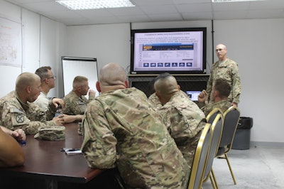 Staff Sgt. Baker on August 13, 2015, instructing a group of soldiers of the 1313th on how to obtain and use a CDL.