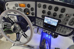 The monitor folds down and slides into the dash when not in use.