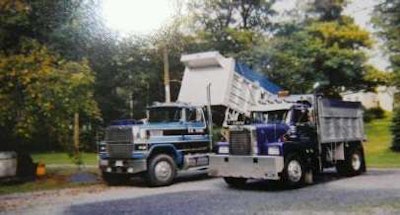 Two of Toms’ dump trucks — he’s a “third-generation dump truck owner in Maryland,” he says.