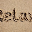 relax-written-in-sand