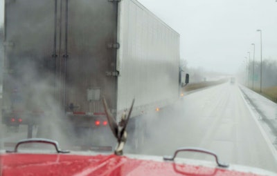 truck-on-highway-in-rain-from-cab-view