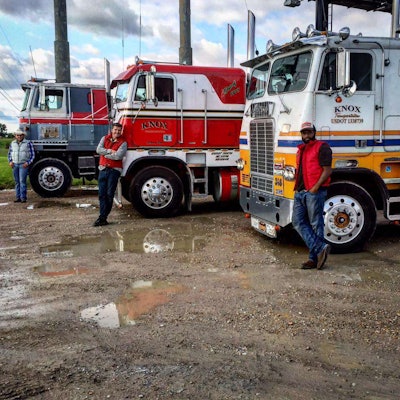 austin yoder, todd campbell and kevin young standing next to semi trucks in Missouri along the way to Idaho