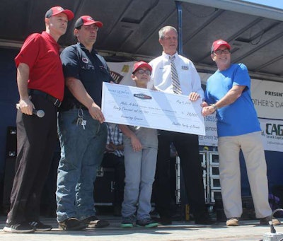 RoadPro VP Chuck White (left) and two member of the company’s drivers council Tom Kyrk and Henry Albert present $20,000 to Make-A-Wish President & CEO Dennis Heron (right) and wish recipient child Justin Perales.
