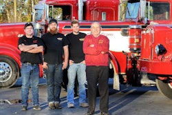 Richard, Rich, Rob, and Kevin Smith standing in front of the Dirty Dozen Kenworth