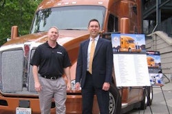 Brad Bentley, president of Fastport (left), and Kurt Swihart, Kenworth marketing director, are shown with the Kenworth T680 76-inch sleeper that will be awarded to trucking’s top military veteran rookie.