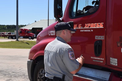 Sgt. Joseph Haralson begins a Level I inspection during CVSA’s annual Roadcheck. The driver was randomly selected, in part for having a high Inspection Selection System safety score, which is shown to DOT officers as trucks roll through the scales.