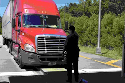 Haralson guides a driver into the inspection barn for the second part of the Level I inspection. In the barn, Haralson will be able to go under the truck to inspect the truck’s brakes.