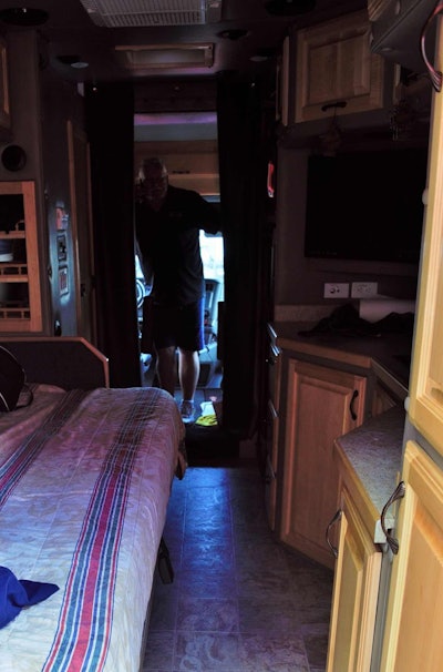 Pictured from just inside the door, the sleeper's interior boasts, at left, a full-size bed and shower/toilet, and at right the kitchenette area -- and plenty of cabinet storage.