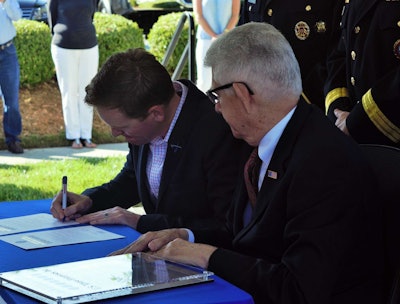 In signing the Employer Support of the Guard and Reserve’s commitment pledge, Fuller (left) was joined by ESGR Chief of Employer Outreach Tom Bullock.