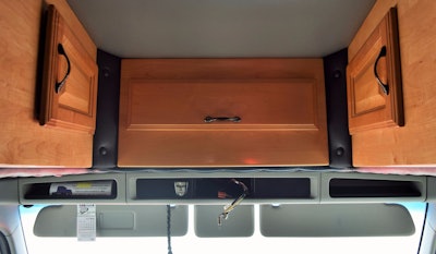 Further storage is positioned above the driver's cab.