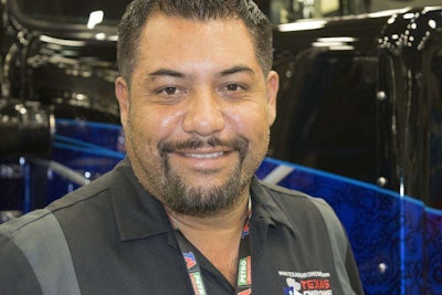 Roland Mendez standing with Project TOC on the show floor at GATS.