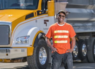 Tucci & Sons driver Ernest âErnieâ Grice, 59, appreciations to the T880 Super Dumpâs Allison 4500 RDS 6-speed automatic transmission. Dynamic shift sensing allows the transmission to automatically choose gears based on the vehicleâs weight and road grade. âI donât have a sore shoulder at the end of the day from all that shifting I used to doâ in the stop-and-go application that is much of the Tucci & Sons delivery business. âWhen I first started driving for Tucci & Sons (in 1990), it wasnât a big deal. Now that Iâm older, it certainly is.â Photo courtesy of Colby Williams, Fueled Photography.