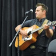 Jason Lee Wilson rocked the crowd with “Truck Stop Betty,” a song he wrote, in the Trucker Talent Search finale held Aug. 26. (Photo by Todd Dills)