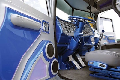 The door panels and dash of Lindamood’s cab are trimmed out in blue and silver, and the shifter carries out the theme in chrome topped with a blue knob.