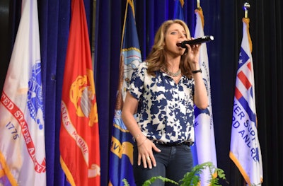Janine Stange sings the national anthem at the Great American Trucking Show. She also performed this year at the Mid-America Trucking Show and last year at Wreaths Across America, a program that relies on fleets to help get wreaths placed at military cemeteries during the holidays. She will perform for the newly elected president Jan. 20 at the American Legion Salute to Heroes Inaugural Ball.