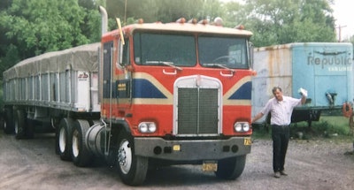 Maxwell with his Kenworth K100, a model year of around 1984. The flatbed trailer had removable sides.