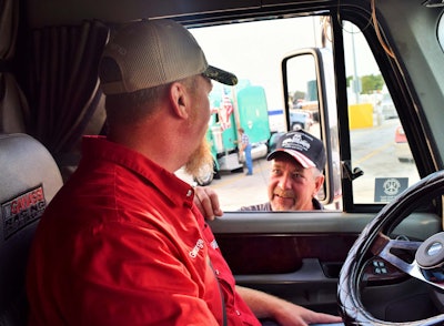Navy veteran George Parker (left) talking to Air Force vet Jerry Novak from behind the wheel of Parker’s well-known Freightliner Coronado.