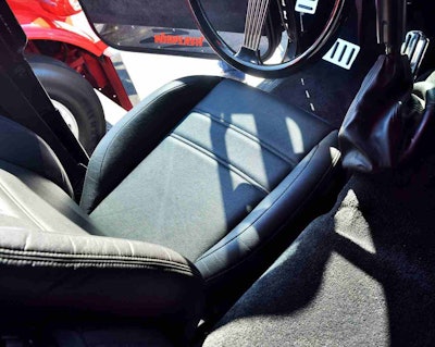 Laying household carpet throughout the interior, including over the doghouse;