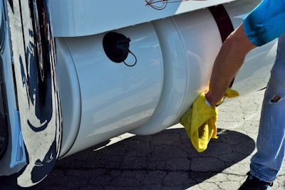 Among others attending to the show at 4 State were Patrone Livestock driver Matt Buhler, here shown wiping down the driver-side tanks after positioning the rig out front for the show.
