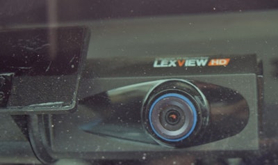 The forward-facing camera, mounted just left of center at the top of the windshield, in independent Howard Salmon’s 1999 KW.