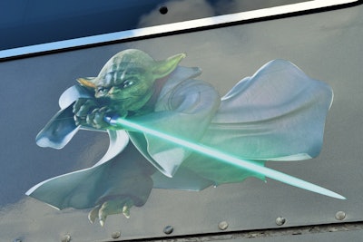 Tammy Groom has a thing for Yoda, as this graphic, on either side of the Grooms’ “Mothership” rig, attests. She’s still looking for a Yoda hood ornament, but found a “Paid for, it is” plate to add to the front bumper. Run through more of the rig’s features in the video below.
