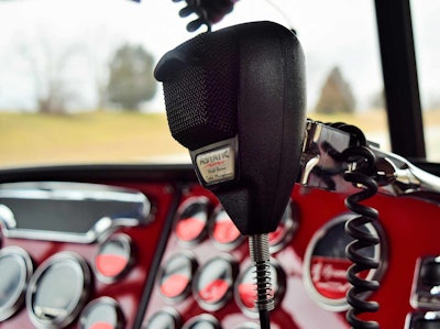 CB mic in a semi-truck with a red dash