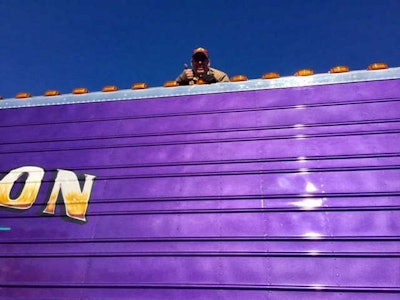 John Jaikes fixes a light on his Precision Transportation rig in the PKY show truck competition at MATS 2017.