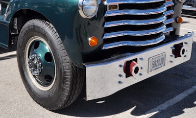 The truck has split rim (two-piece) wheels and bias tires with tubes. The bumper was taken off a Mack to replace the original one.