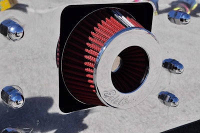 If those round devices in the bumper look like air breathers, well, they are. They feed air to the carburetor.