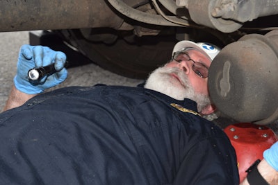 McCadden gets down and dirty scooting around on a roller-board under Henley’s truck.