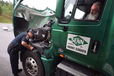 Inspector Steve Chattin checks the truck driven by Al Breland of Senn Freight Lines, which is based in Newberry, South Carolina.