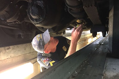 Inspector Chris McNatt checks a chassis at Alabama’s weigh station near the Georgia state line Tuesday, the opening day of International Roadcheck.