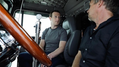 Facebook founder Mark Zuckerberg (left) speaks with a truck driver Friday at the Iowa 80 Truckstop in Walcott, Iowa. (Facebook photo)