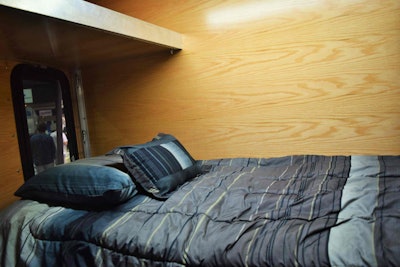 While it’s no 72-inch raised-roof stand-up, given the minimal space available, McNeal’s sleeper concept is surprisingly spacious, with windows both sides that tilt open, a roof vent/fan, and a microwave on the driver side above the bed.