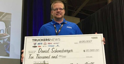 Daniel Shonebarger showing off his $10,000 check Friday after being named Trucking’s Top Rookie.