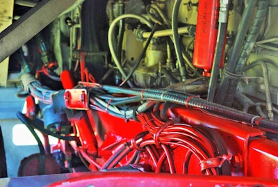 A look down the frame rails from the rear of the cab into the engine compartment shows in part just how much the owner-operator has done under the cab, as it were, these recent years to the nearly 30-year-old tractor. It’s powered by a 350 Cummins Big Cam 4, fully mechanical engine. Catch plenty more views in the vid.
